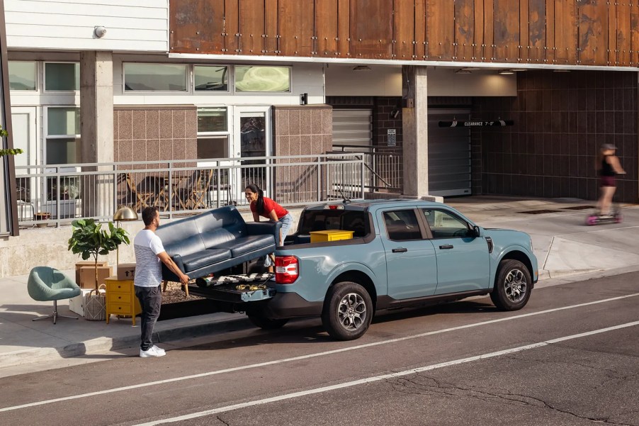 A grey 2022 Ford Maverick has supplies loaded into its bed.