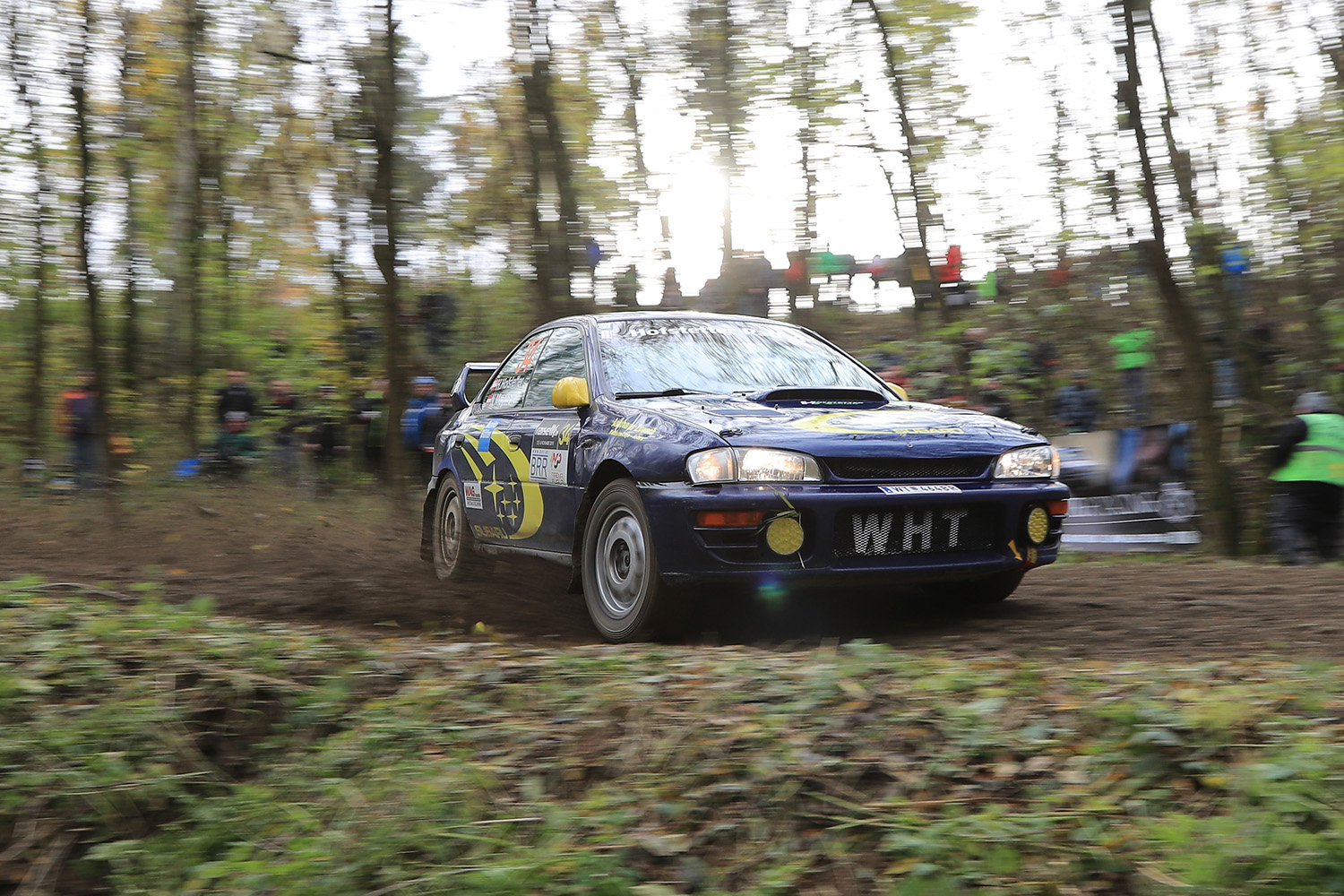 GC8 Subaru Impreza STI 22B Style Restomod Rally Car Sliding Sideways around a muddy rally stage corner