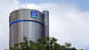 The cylinder shaped GM building in front of a white clouded sky.