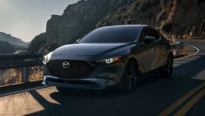 Gray 2022 Mazda3 driving on a mountain road