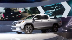 A Honda Ridgeline mid-size truck sits on display at an auto show.