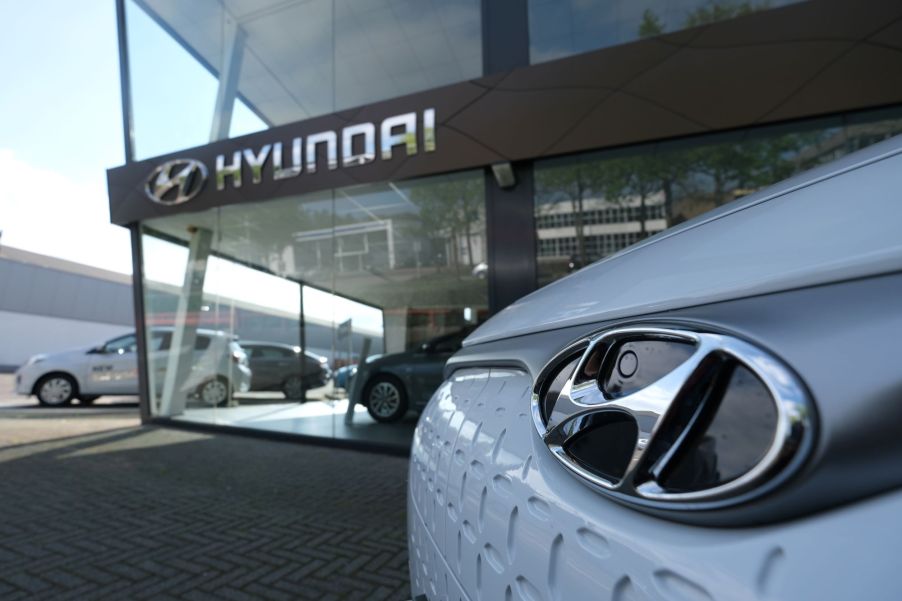 The outside of a Hyundai dealership with a close up of a white Hyundai vehicle.