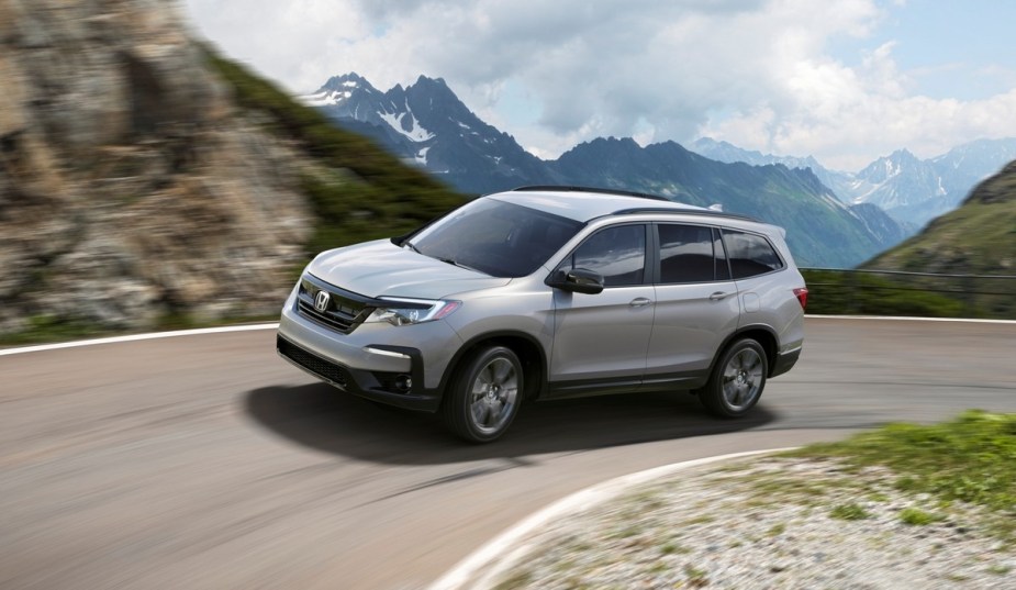 Lunar Silver Metallic 2022 Honda Pilot driving on a mountain road