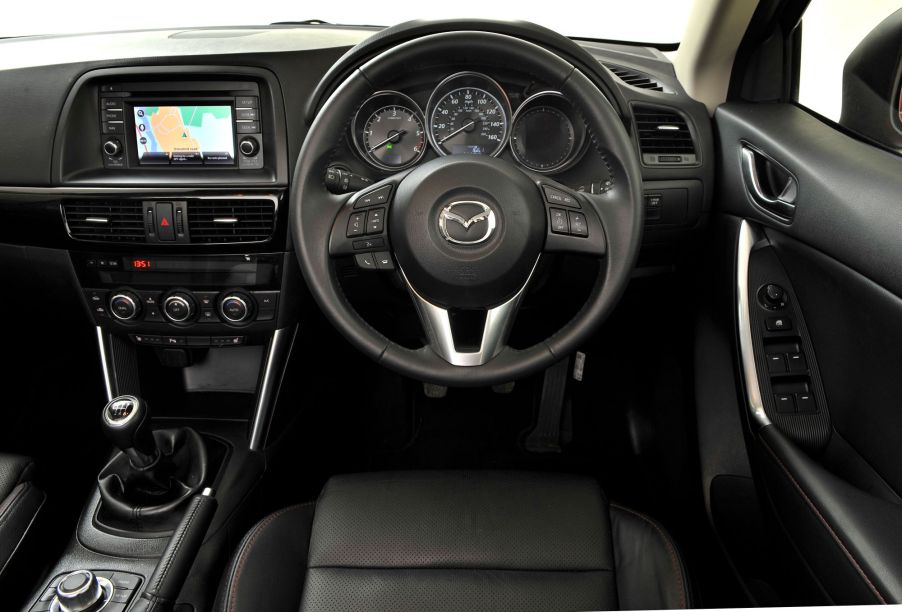 A Mazda's interior with knobs and buttons.