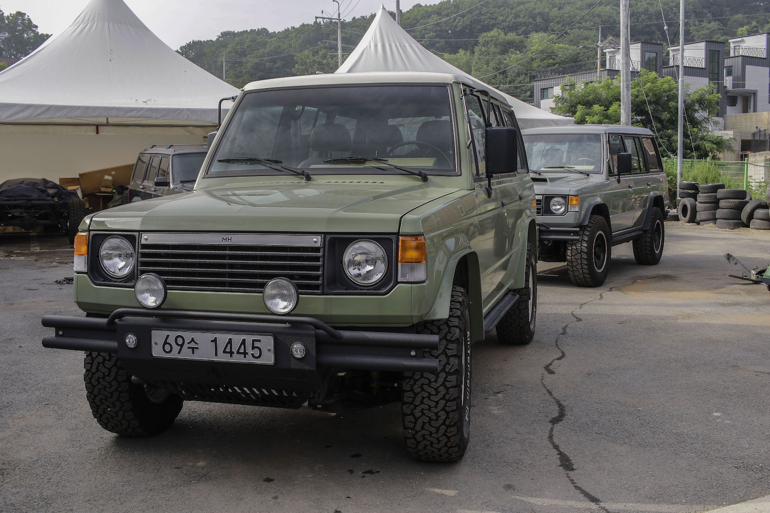 Two restored Mitsubishi Pajero SUVs.