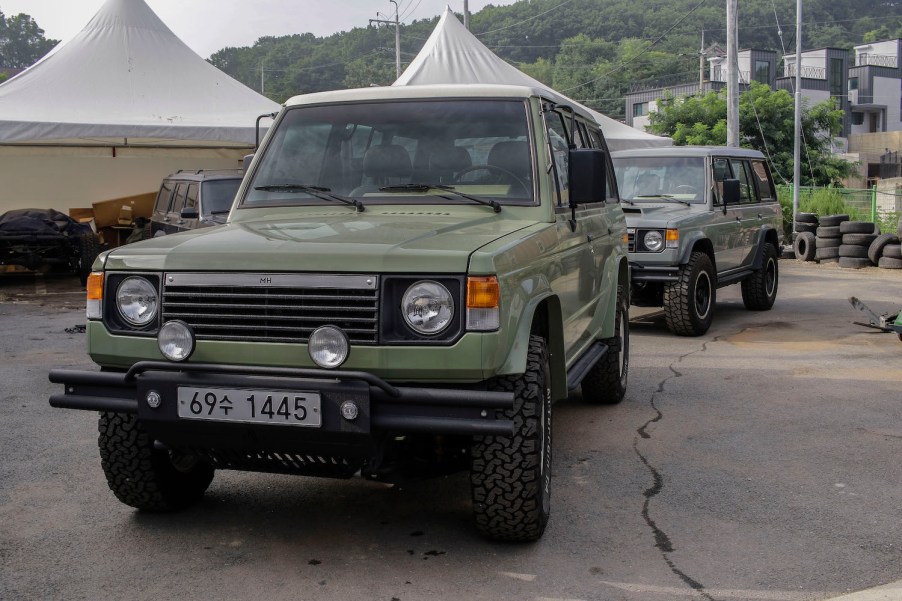 Two restored Mitsubishi Pajero SUVs.