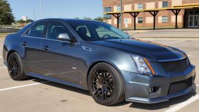 A modified gray 2009 Cadillac CTS-V Sedan in a school parking lot