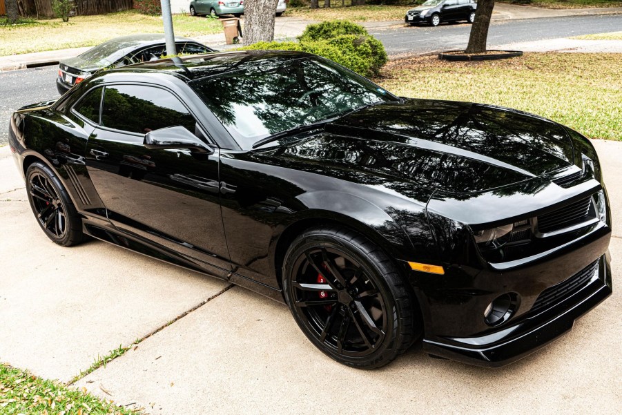 A black modified 2010 Chevrolet Camaro SS on a driveway