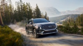 Portofino Gray 2022 Hyundai Santa Fe Hybrid driving on a dirt road