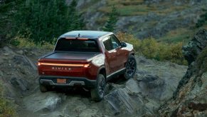 Rear view of and orange-red 2022 Rivian R1T, the first production electric pick up truck.