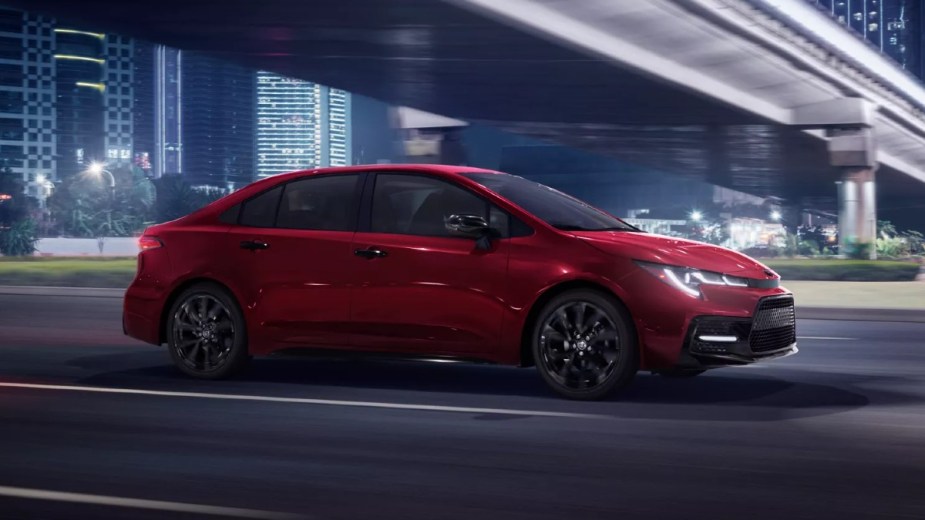 Red 2022 Toyota Corolla driving under an overpass