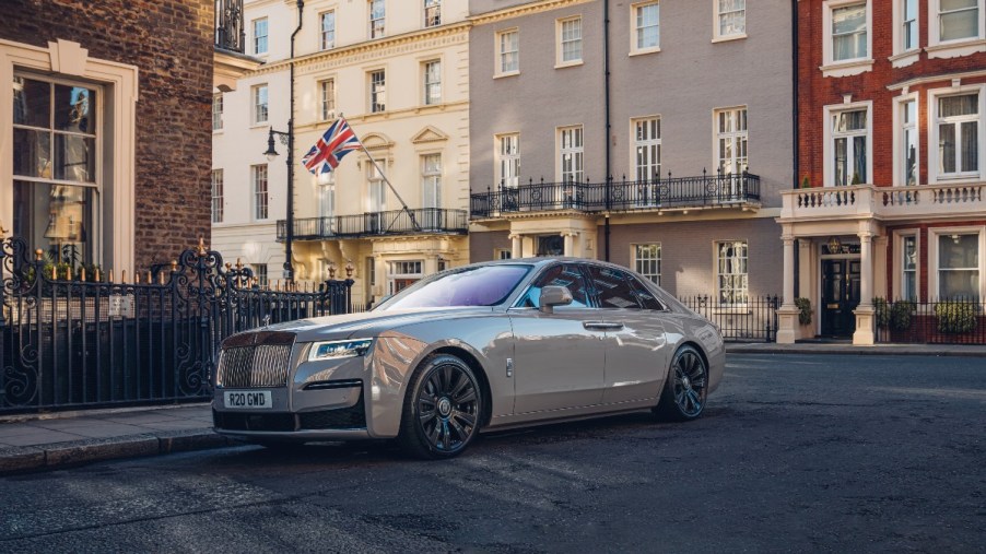 a silver rolls-royce ghost is parked on a london street