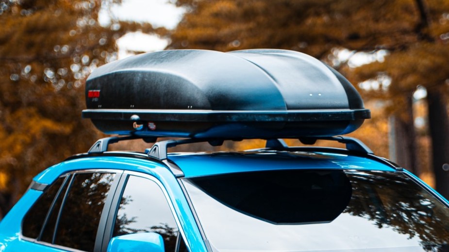 a roof top box onto of a suv, one way to cut your efficiency and spend more money