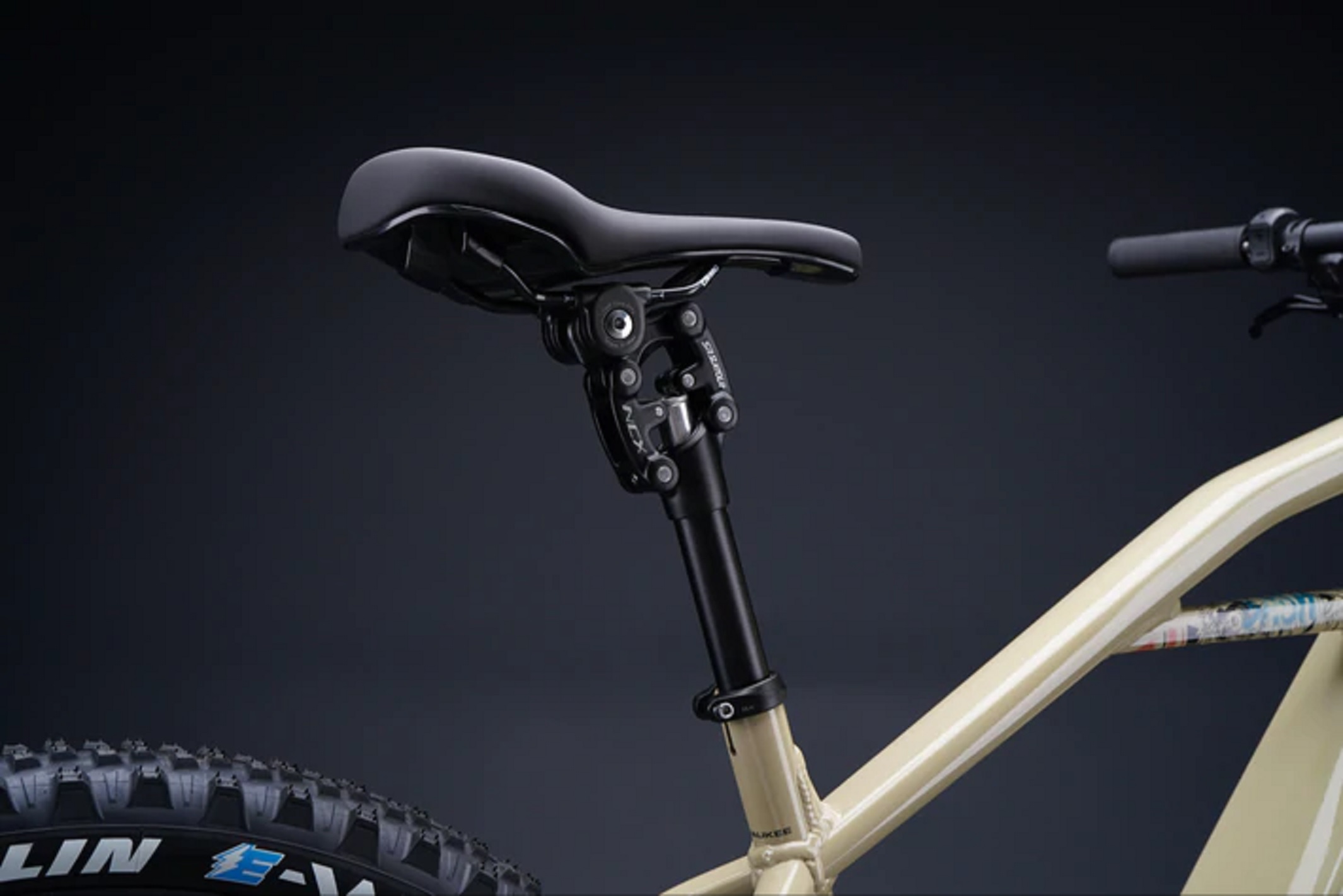 The SR Suntour NCX suspension seat post on a tan Serial 1 BASH/MTN electric mountain bike