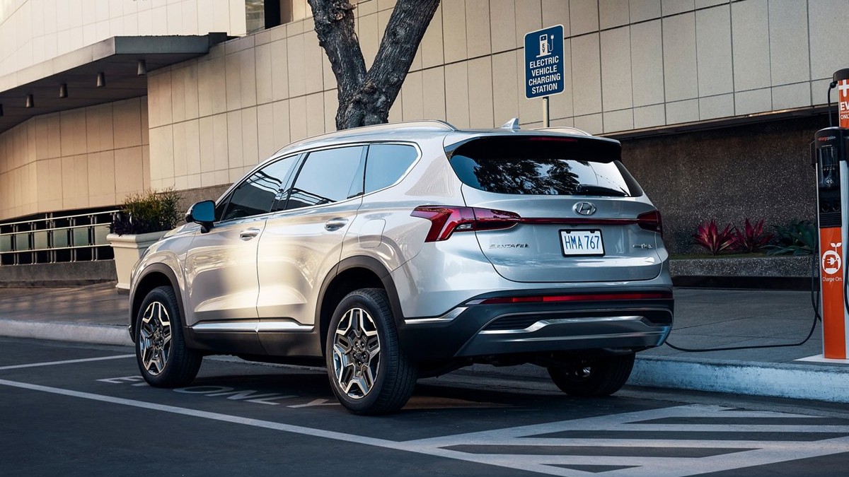 Shimmering Silver 2022 Hyundai Santa Fe PHEV charging at a charging station