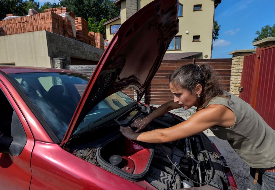 A person working on a car, that possibly had a check engine light on.