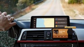 Spotify Car Thing mounted on a dashboard. It requires a bluetooth connection to your phone and the price is $90.