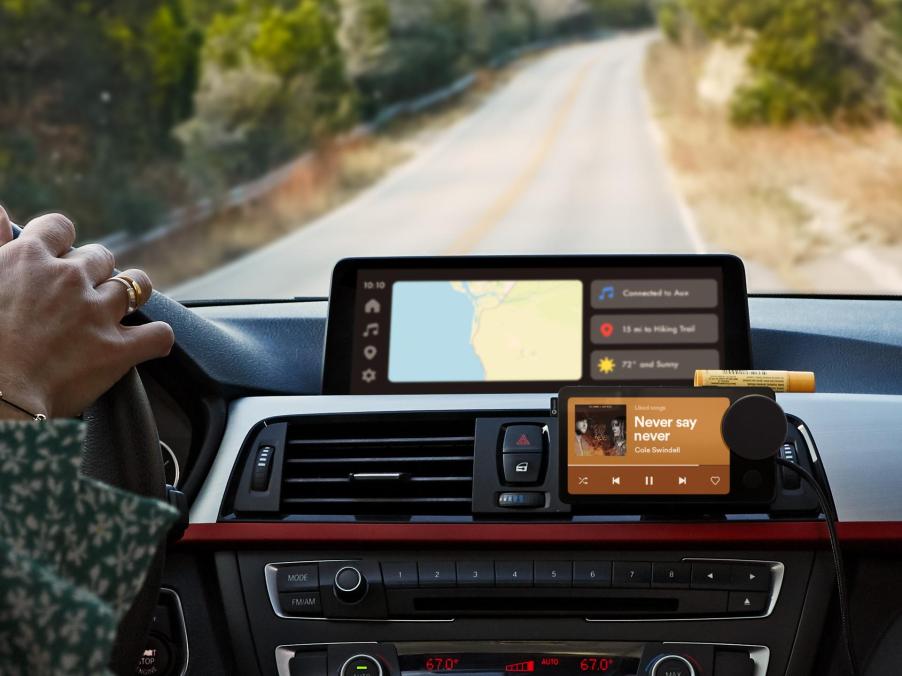 Spotify Car Thing mounted on a dashboard. It requires a bluetooth connection to your phone and the price is $90.