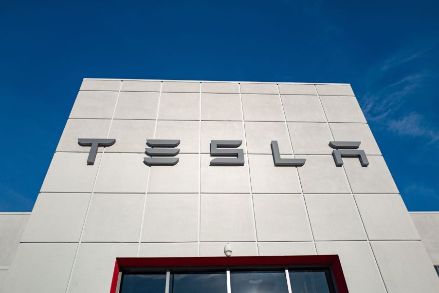 The outside of a Tesla building with Tesla, where Tesla cars have been recalled, written on the outside.