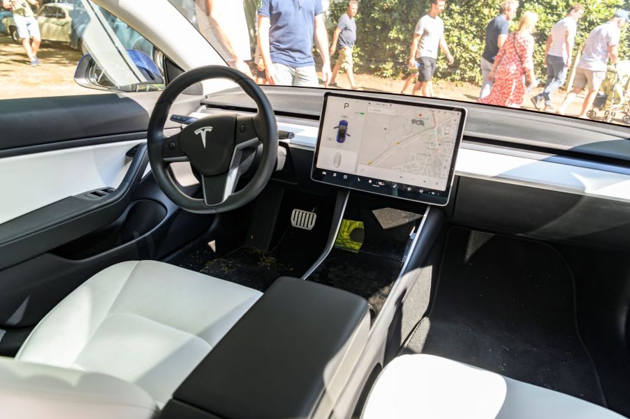 The inside of a Tesla displaying the Tesla screen.