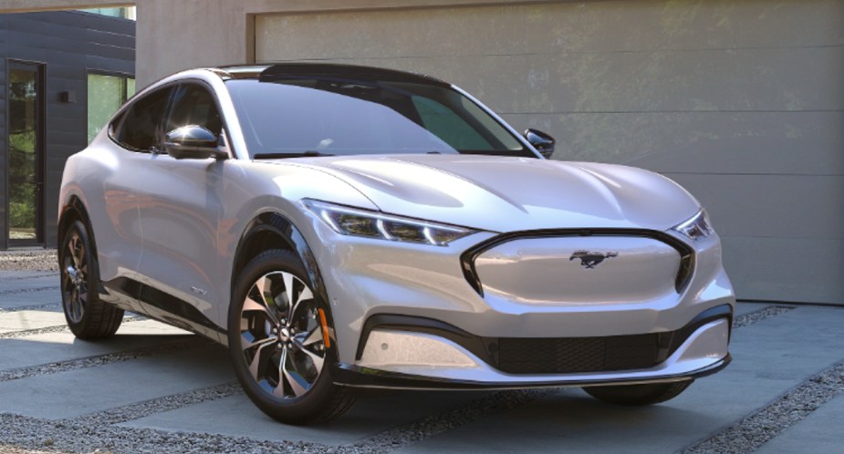 A white 2022 Ford Mustang Mach-E electric SUV is parked. 