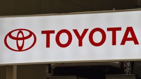 A white Toyota sign with Toyota written in red.