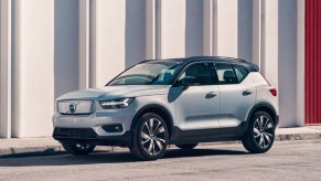 A white Volvo XC40 Recharge Pure Electric SUV is parked outside.