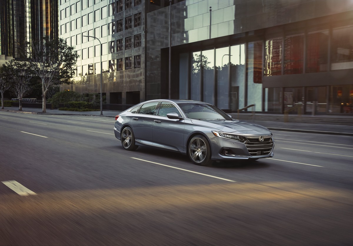 Silver 2022 Honda Accord Touring sedan driving through a city.