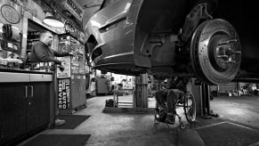 Brake pad maintenance on a Ford Mustang done by IFBB Pro Wheelchair Bodybuilder Johnny Quinn