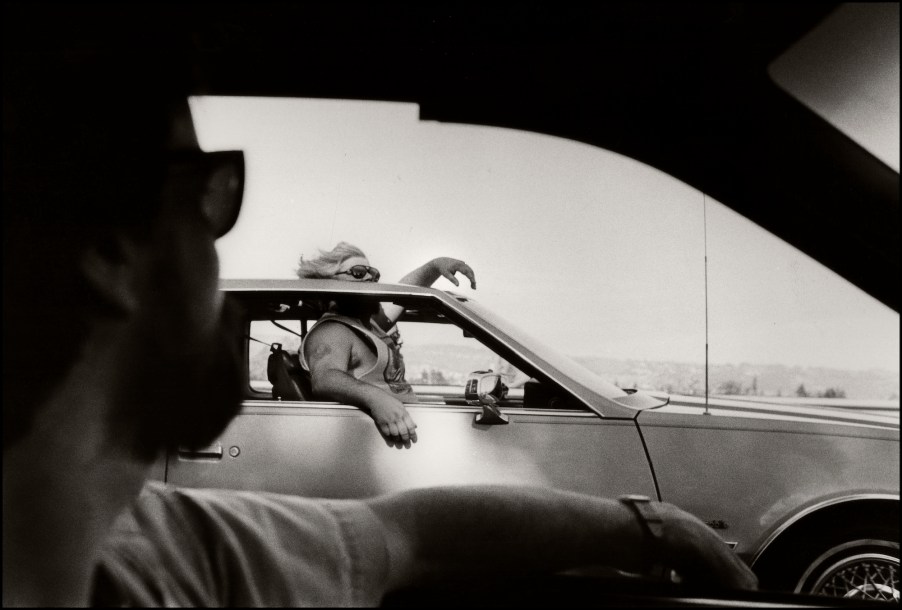 Passenger looks out ff the sunroof