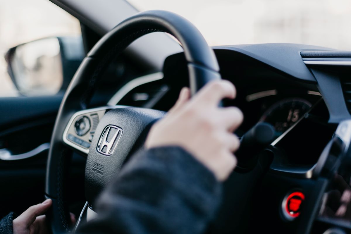 Close-up view of a Honda steering wheel. All 2023 Honda cars will include free scheduled maintenance plans