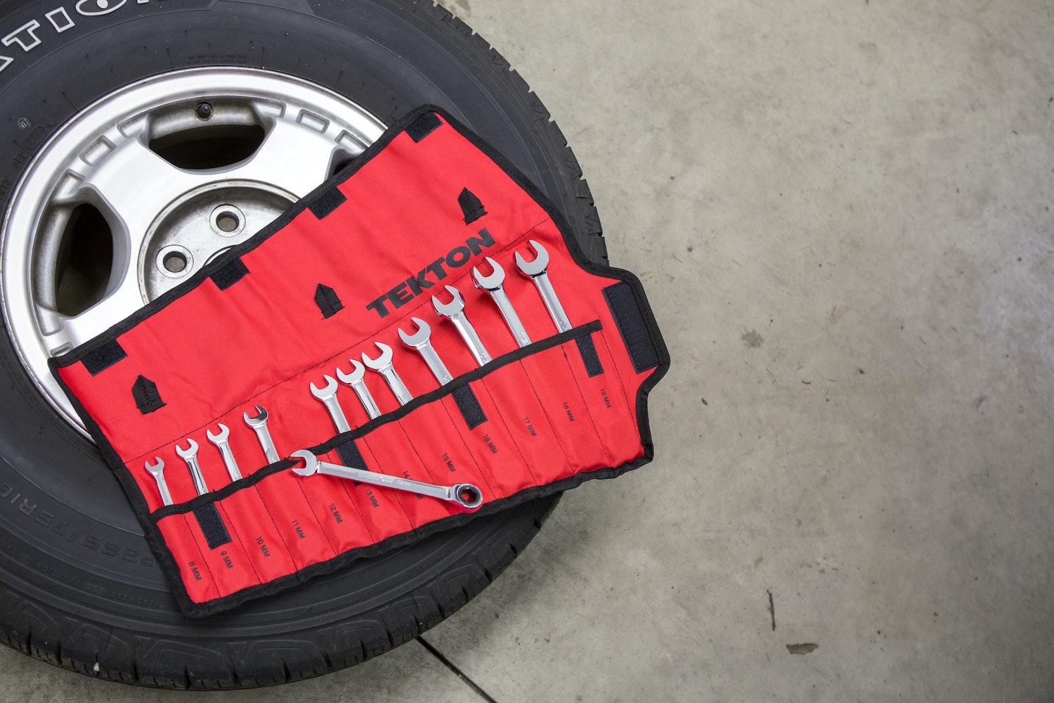 Stock photo of a toolkit on a spare tire being changed.