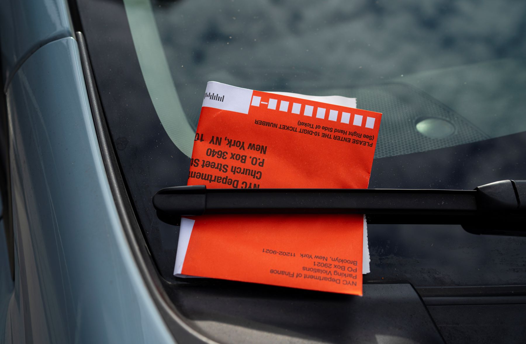 A vehicle paperwork and title attached to a windshield