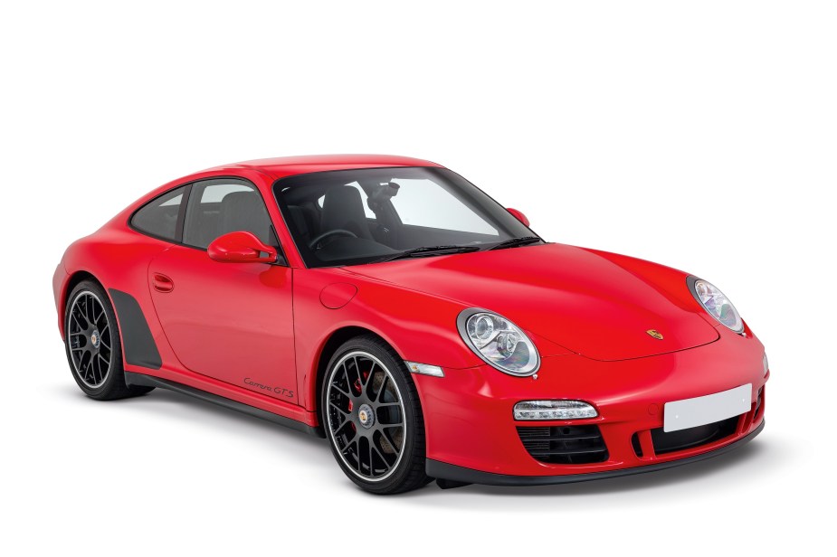 A red-and-black 2011 997 Porsche 911 Carrera GTS in a white studio