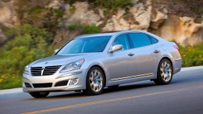 A silver 2011 Hyundai Equus full-size sedan driving down a canyon road