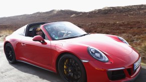 A red 2017 Porsche 991.2 911 Targa 4 GTS on a German road