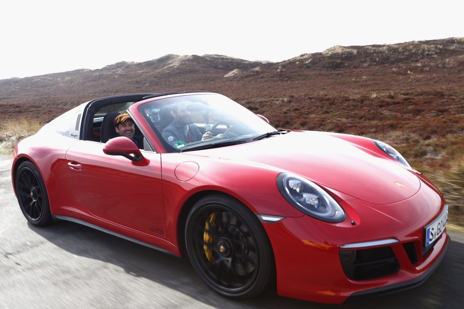 A red 2017 Porsche 991.2 911 Targa 4 GTS on a German road