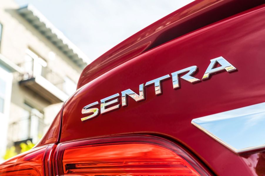 Silver SENTRA badging on a red 2019 Nissan Sentra compact sedan