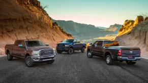 Three Ram heavy duty trucks on a mountain road