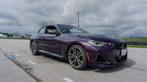 The front 3/4 view of a purple 2022 BMW M240i xDrive Coupe on Road America's autocross course