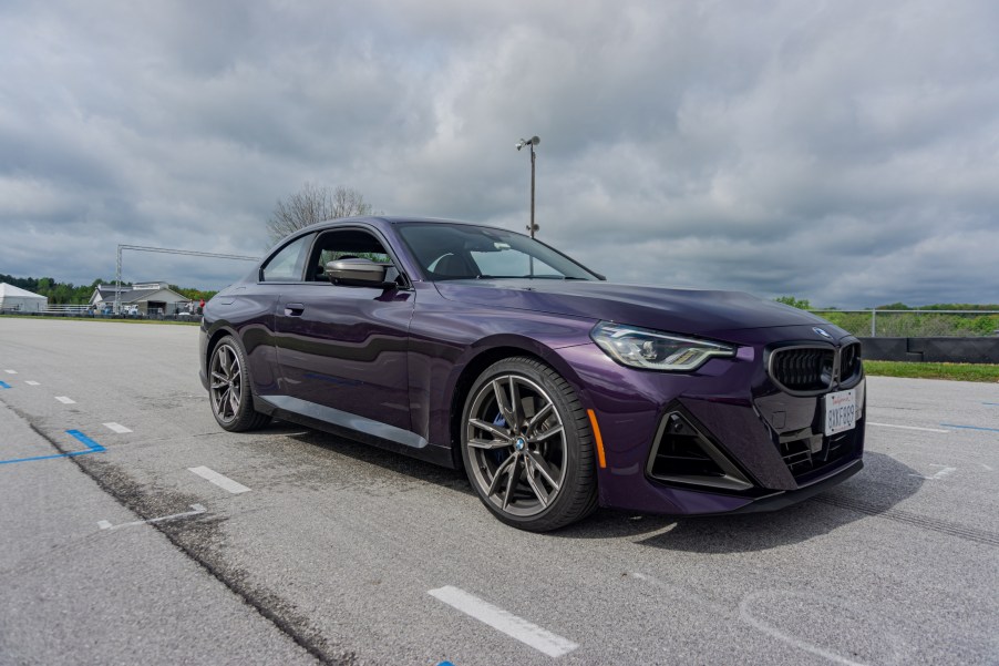 The front 3/4 view of a purple 2022 BMW M240i xDrive Coupe on Road America's autocross course