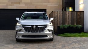 A 2022 Buick Enclave midsize crossover SUV model parked on a cobblestone driveway