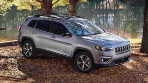 A silver 2022 Jeep Cherokee in the woods.