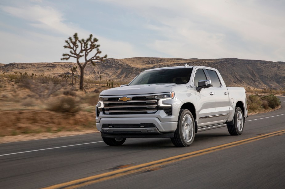 A silver 2022 Chevy Silverado driving down the road. 