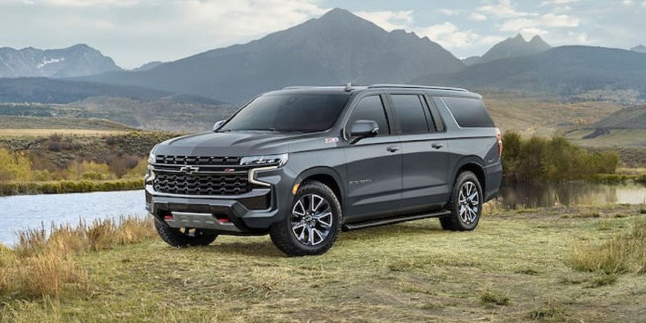 A gray 2022 Chevy Suburban with mountains in the background.