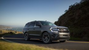 A grey 2022 Ford Expedition driving up a mountain outside.