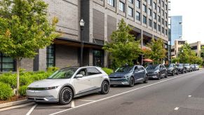 2022 Hyundai Ioniq 5 models parked on the side of a city street near a cafe