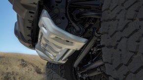 Closeup of a Jeep Gladiator pickup truck's skidplate and solid front axle.