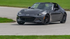 A gray 2022 Mazda MX-5 Miata RF Club going around a racetrack corner