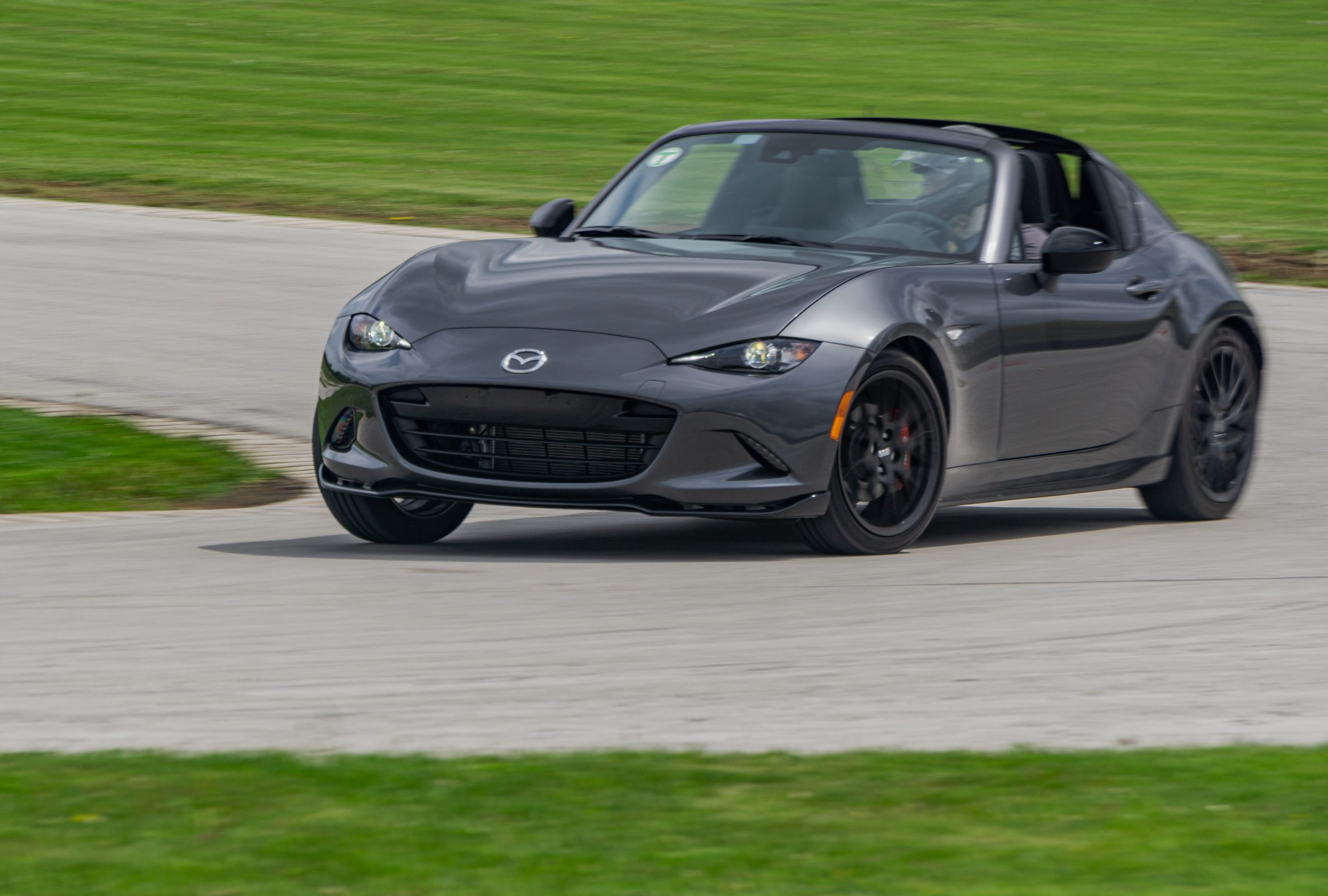 A gray 2022 Mazda MX-5 Miata RF Club going around a racetrack corner